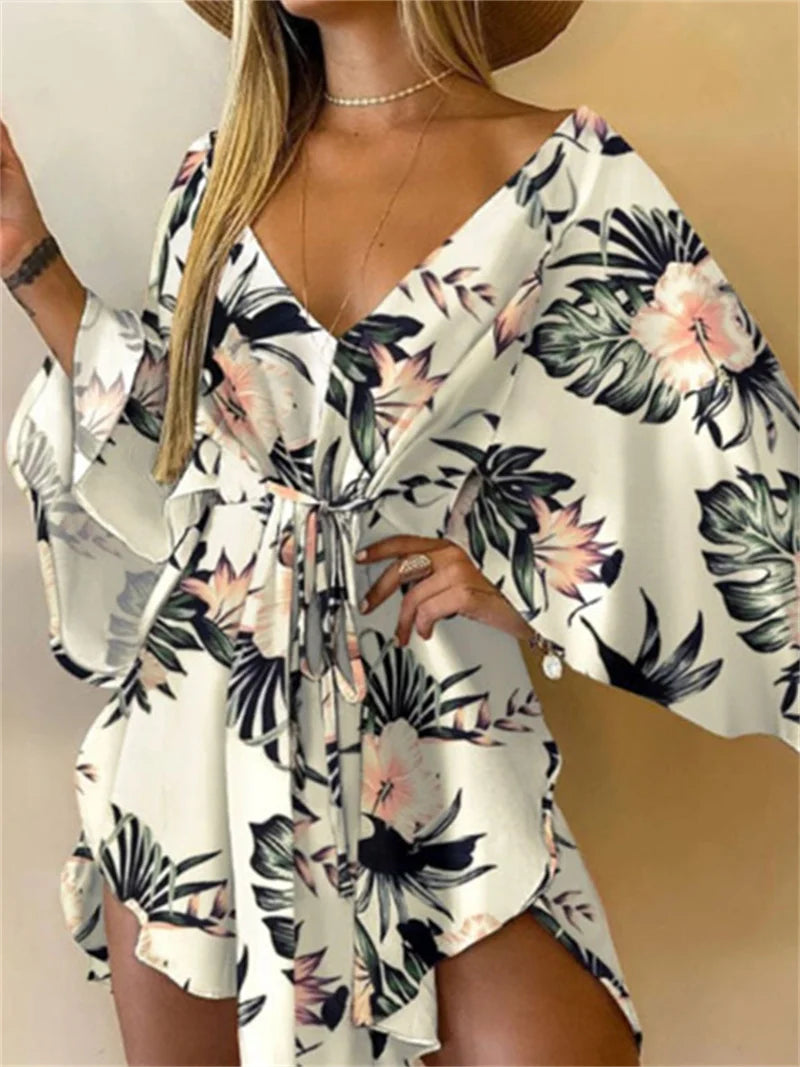 Sexy printed women's dress with a V-neck, wide sleeves, ruffles, and a loose, short floral print, perfect for summer vacations.