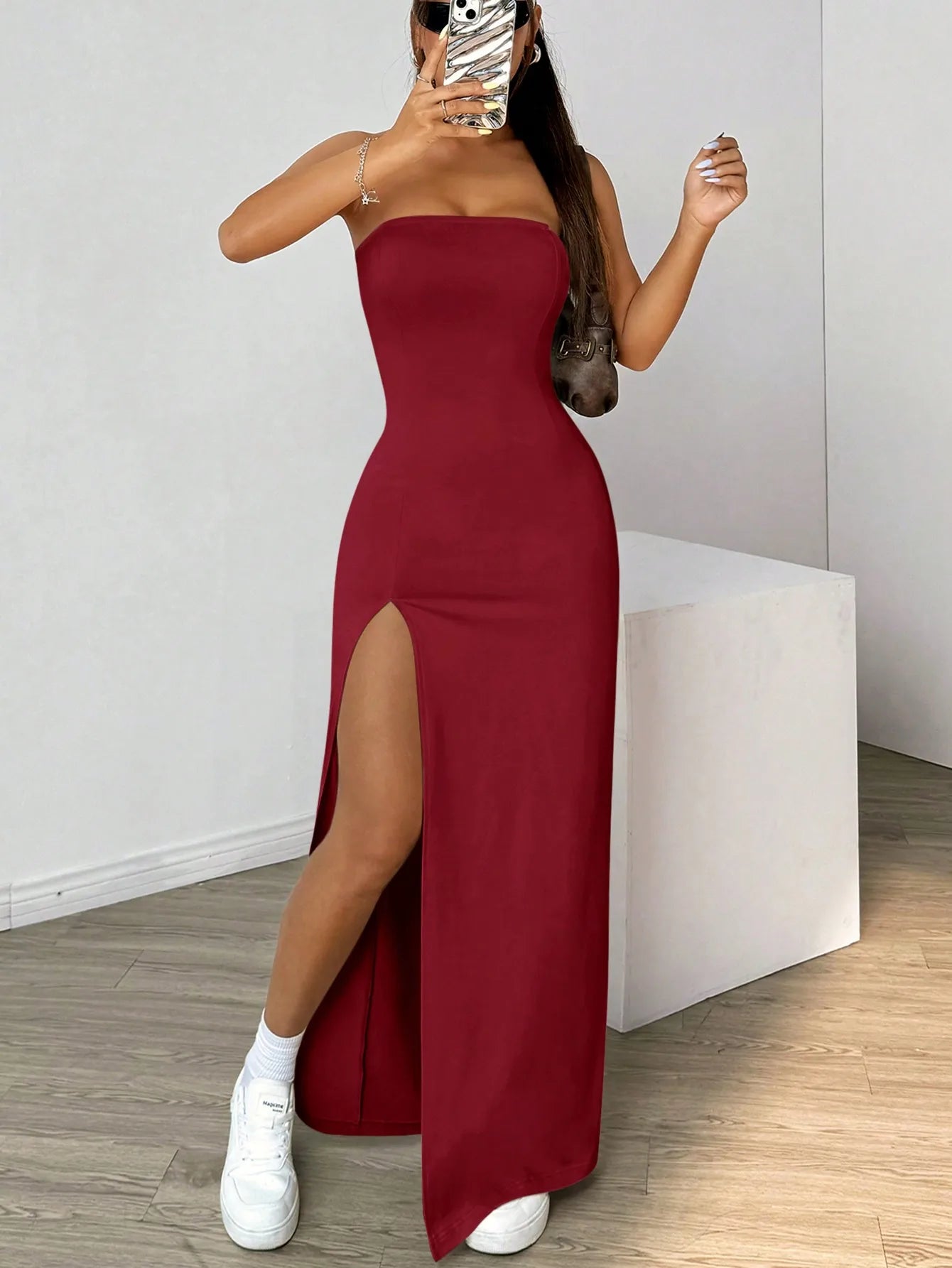 Elegant long strapless dress, with a side slit, in a simple solid color.