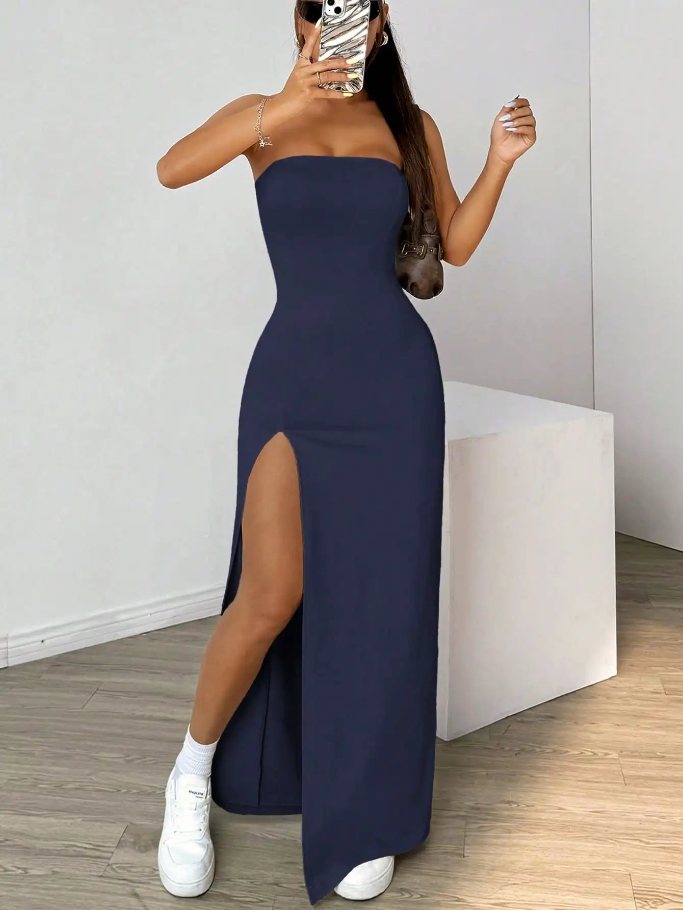 Elegant long strapless dress, with a side slit, in a simple solid color.